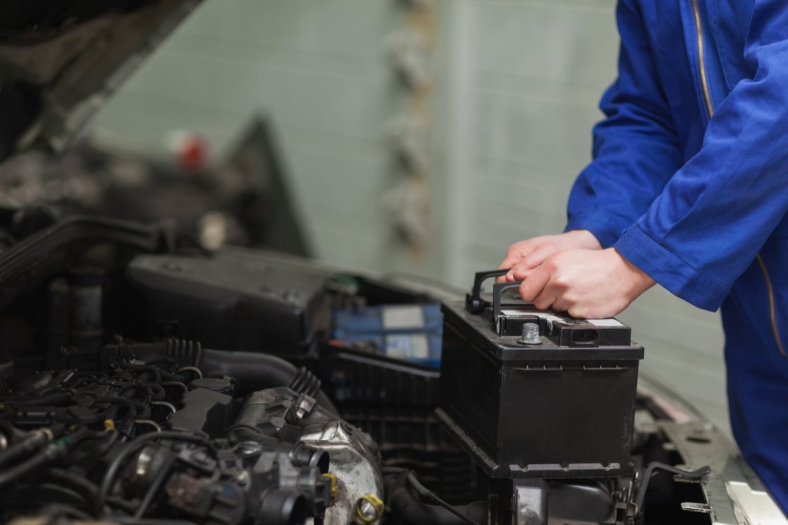 Mechanic changing car battery